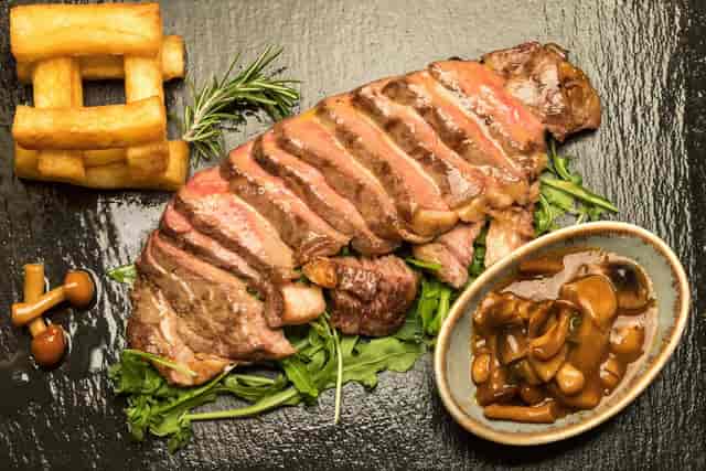 High-end entrée on slate, elegant gala dinner dish for executive boardroom catering.