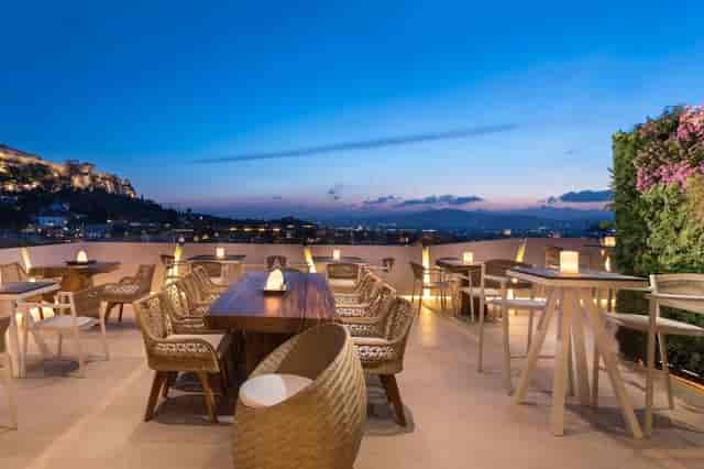 Rooftop event venue in Thiseio with Acropolis view at golden hour for networking or social events.
