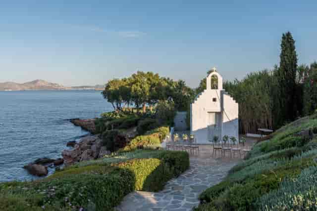 Intimate wedding ceremony at Island Art & Taste gallery with scenic Mediterranean views.
