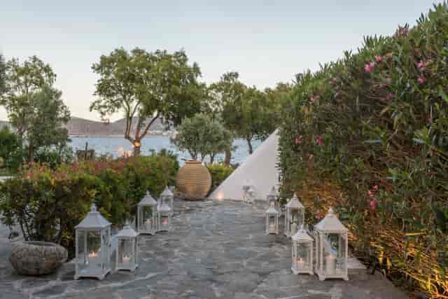 Lantern-lined Mediterranean aisle at Island Art & Taste for romantic wedding event.