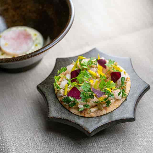 High-end hors d'oeuvres on a plate for networking reception or executive gala catering.
