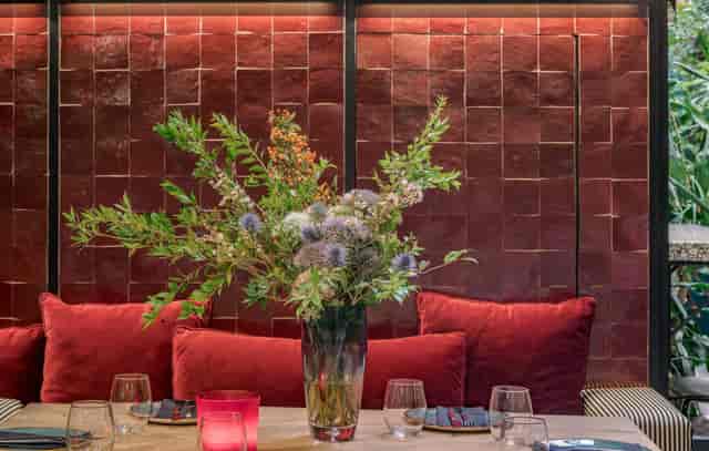Private dining room at Malconi's with velvet decor for exclusive events and upscale client dinners.
