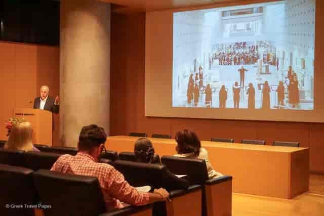 Modern wood-paneled auditorium with tiered seating, ideal for corporate conferences and seminars.