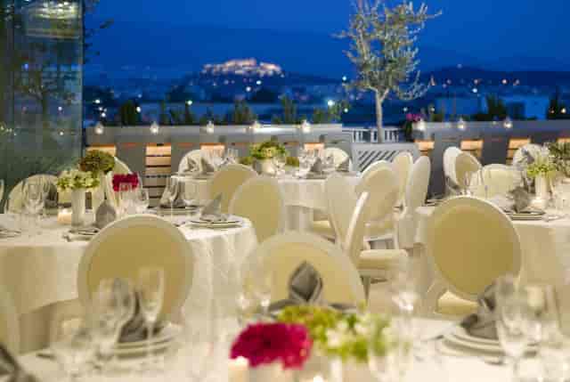 Elegant outdoor gala dinner setup at Eleon Loft with illuminated landmark view.