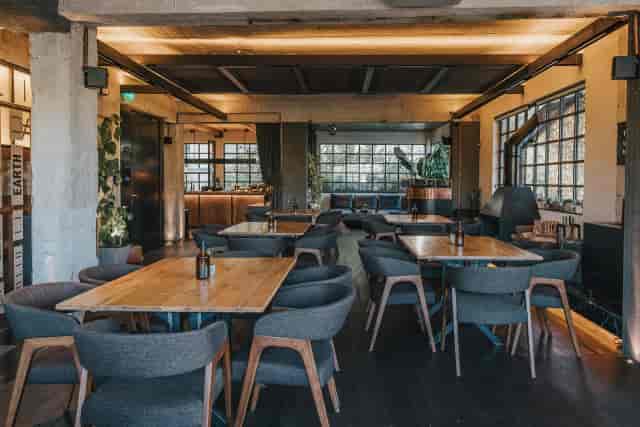 Industrial cabaret space with modular seating for corporate mixers and networking events.