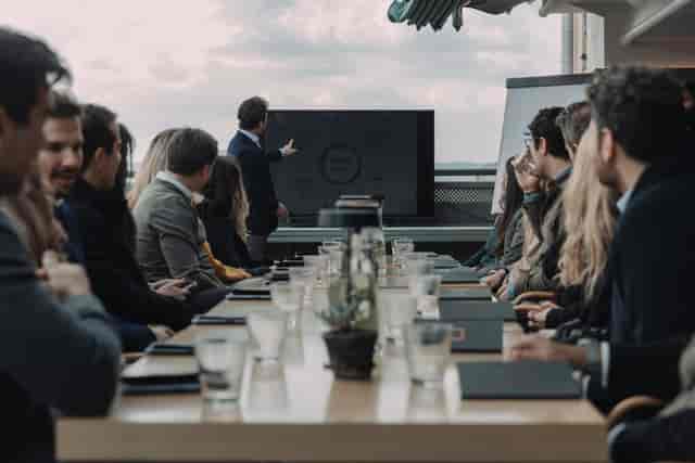 Outdoor corporate boardroom meeting at a conference table for professional event planning.