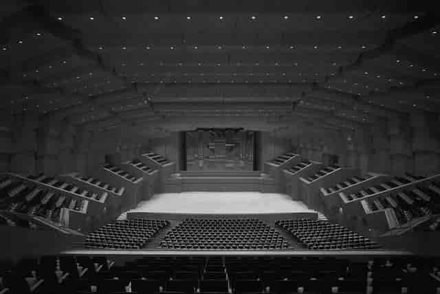 Christos Lambrakis Hall, tiered auditorium stage for professional plenary sessions and keynotes.