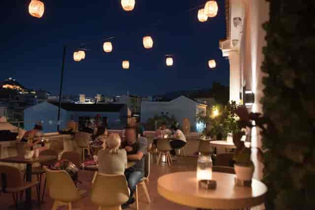 L'Amiral rooftop terrace with bistro lighting for evening networking reception.