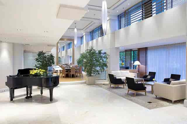 Erato Hotel lobby with upscale lounge and event platform for VIP networking and private dining.