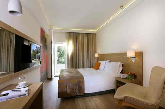 Modern hotel room at Syrene II Golden Age, featuring a dedicated workspace for business travel.