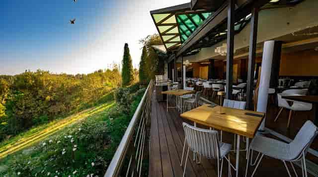 Hytra Restaurant: Elegant outdoor corporate event venue with panoramic skyline views.