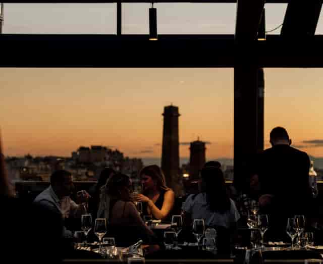 Rooftop cocktail bar at sunset for premium networking reception or corporate incentive dinner.