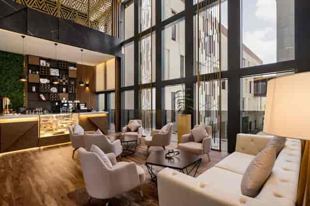Radisson Blu Riyadh breakout area with tiered seating for corporate networking and events.