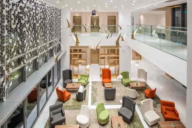 Modern hotel lobby with lounge seating for networking events and corporate breakout sessions.