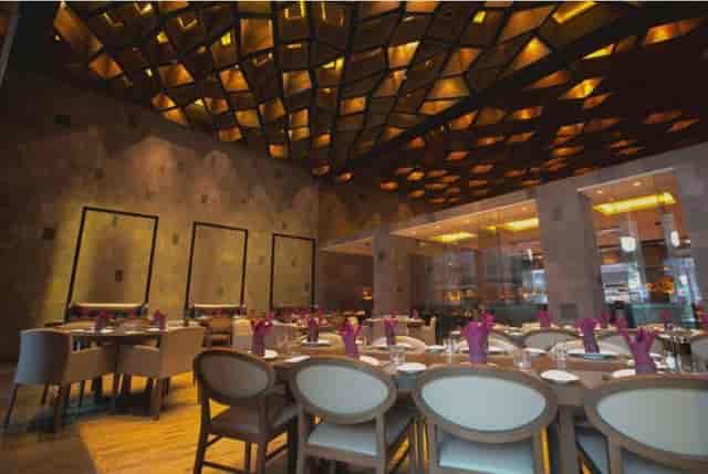 Upscale event space with coffered ceilings for corporate dinners and VIP receptions.