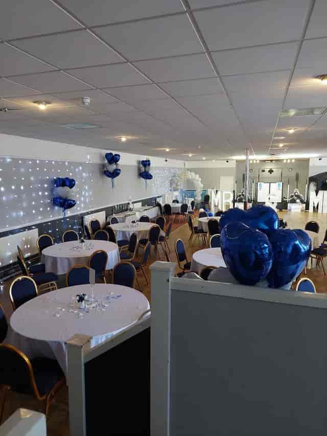 Wedding reception at Dartford Conservative Club with round tables and Mr & Mrs marquee lights.