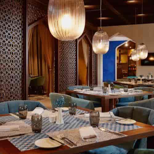 AlUla Shaza Riyadh dining space with geometric fretwork for executive luncheons and events.