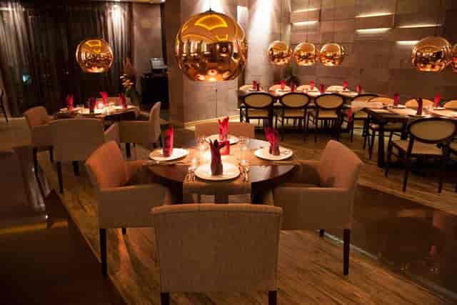 Sophisticated restaurant for corporate dinners and high-end networking events with pendant lighting.
