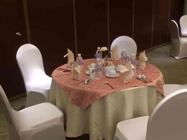 Cramped breakout room setup with uneven linens at Executives Hotel Al Azizia for corporate events.