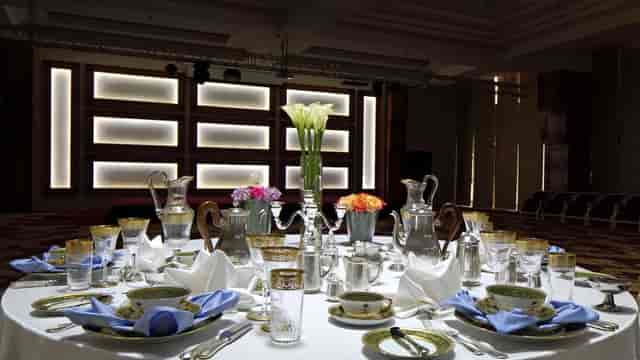 Formal banquet hall with silver service for a corporate gala or luxury event.