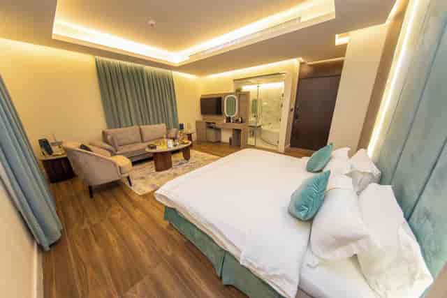 Luxury hotel suite with meeting lounge and bedroom for VIP executive business events.