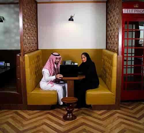 Private high-backed booth in Al Akaria Plaza coworking space for collaborative business meetings.