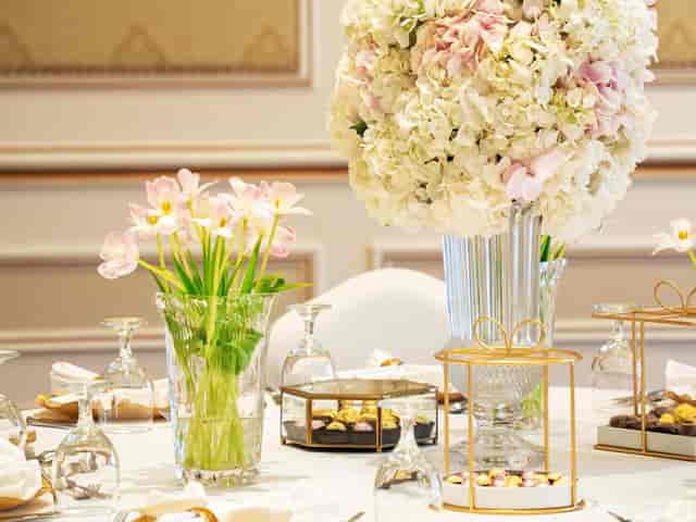 Elegant wedding gala table setting with floral centerpiece at Triumph Al Aziziyah Boutique Hotel.
