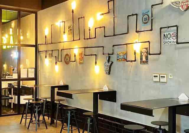 Modern industrial restaurant seating at Ayan Hotel for corporate networking and breakout sessions.
