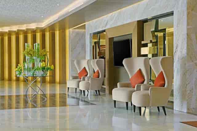 Modern meeting room at DoubleTree by Hilton Riyadh, featuring elegant chairs and floral decor.