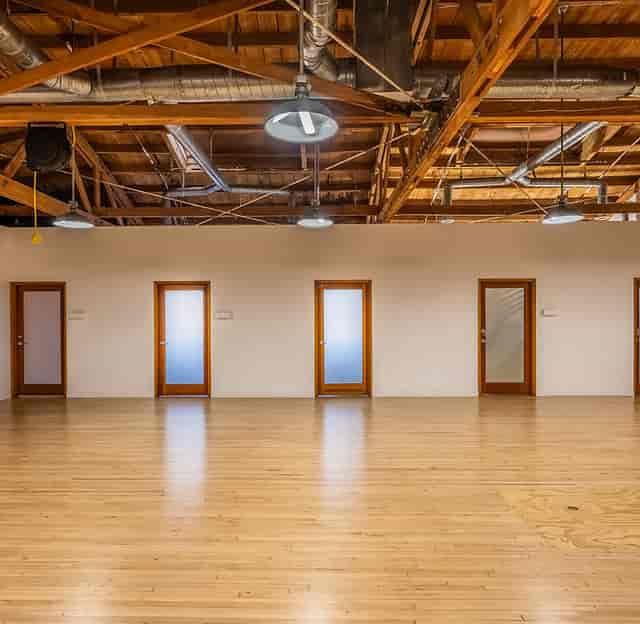 Historic Hudson Studios industrial venue with timber-truss ceilings for workshops and events.