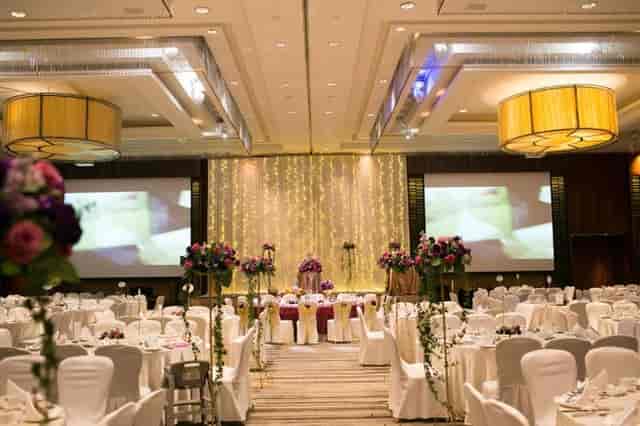 Grand Ballroom at Amara Singapore with stage, fairy lights, and round tables for wedding galas.