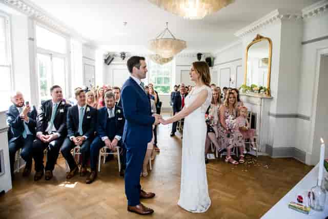 Elegant wedding ceremony in Belair House ballroom with high ceilings for traditional venue hire.