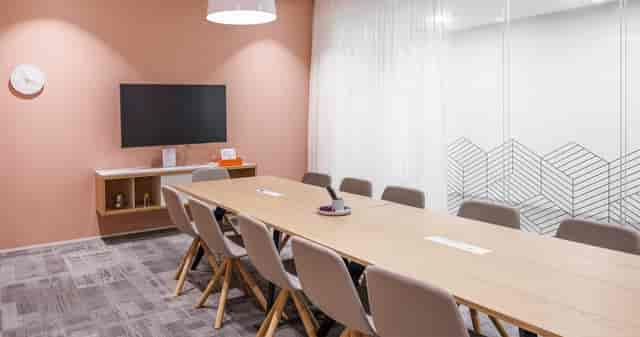 Minimalist boardroom with A/V for 10 guests, ideal for team collaboration and corporate meetings.