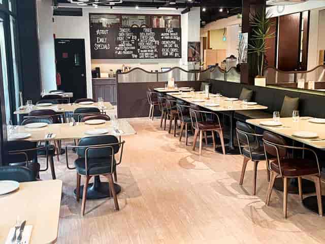 Modern restaurant dining space with booth seating for corporate luncheons and networking events.