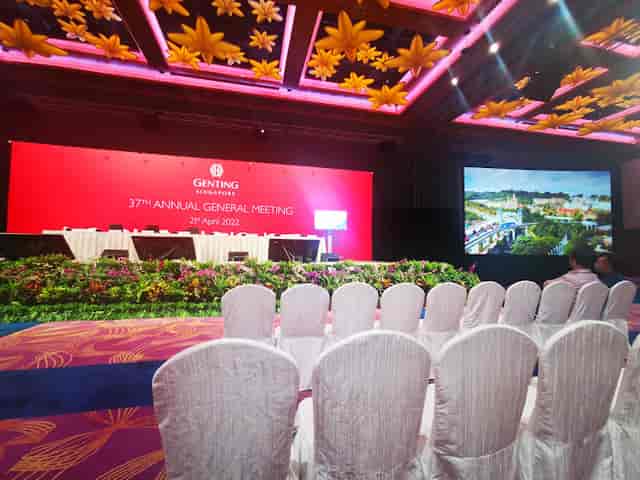 Revelry Hall corporate AGM with LED stage and floral decor; luxury event venue seating.