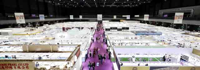 Trade show floor with modular booths and overhead signage for corporate exhibition planning.