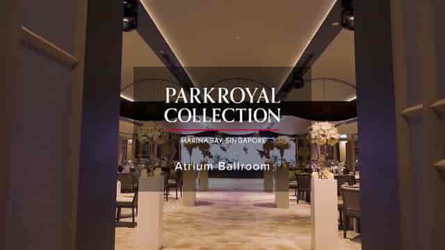 Elegant Atrium Ballroom entrance with floral pedestals for luxury gala or corporate banquet.