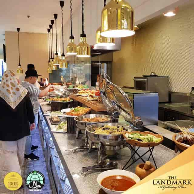 Buffet setup in The Landmark restaurant with warm pendant lighting for catering events.
