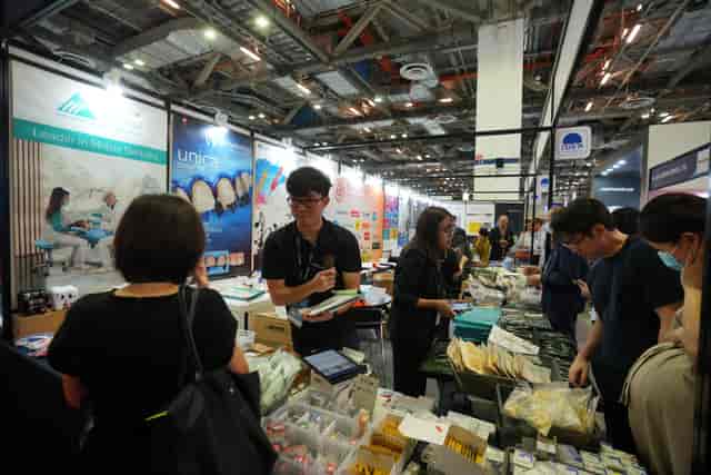 IDEM trade show floor: high-engagement branded booth during professional dental exhibition event.