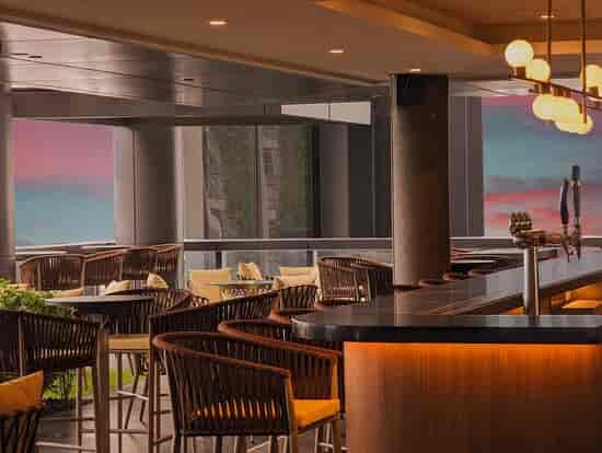 Cooling Tower Rooftop Bar: Sunset reception and networking venue at Carlton City Hotel.