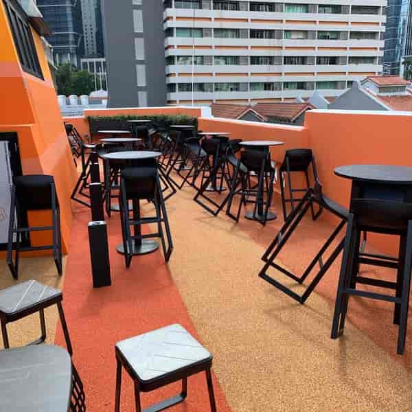 Messy rooftop event space at ST Signature Tanjong Pagar with scattered chairs for venue scouting.