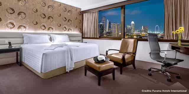 Furama City Centre executive room with workspace and skyline view for corporate events and meetings.