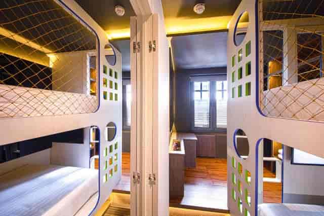 Modern capsule hotel private room for student group travel and corporate team-building retreats.