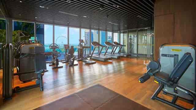 Luxury hotel fitness center with skyline view for corporate wellness and business travel.