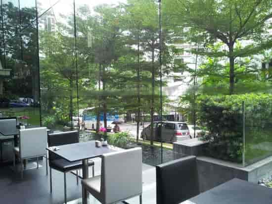 Bright networking space with glass walls and biophilic design for corporate events and workshops.