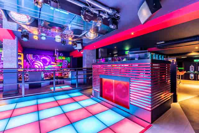 Neon-lit Vinyl Cambridge dance floor for corporate events and networking.