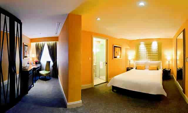 The Scarlet Singapore hotel suite featuring a dedicated workspace, ideal for business travel.