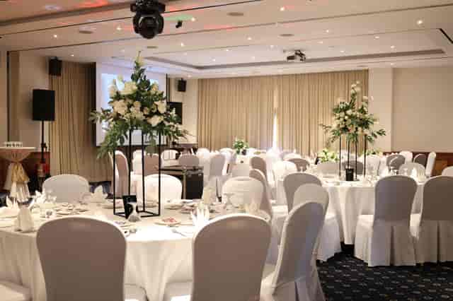 Stuart Room at The British Club: banquet ballroom with floral centerpieces for weddings and galas.