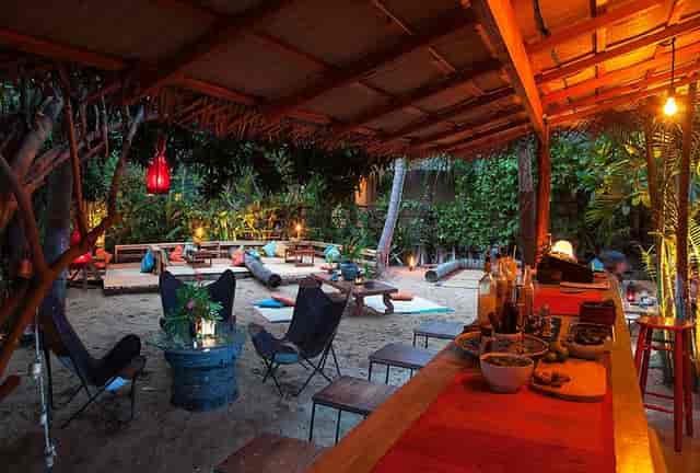 Outdoor lounge with floor seating on sand, perfect for casual breakout spaces or incentive events.