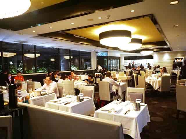 Morton's Steakhouse dining room with white linen for corporate dinners and VIP networking events.